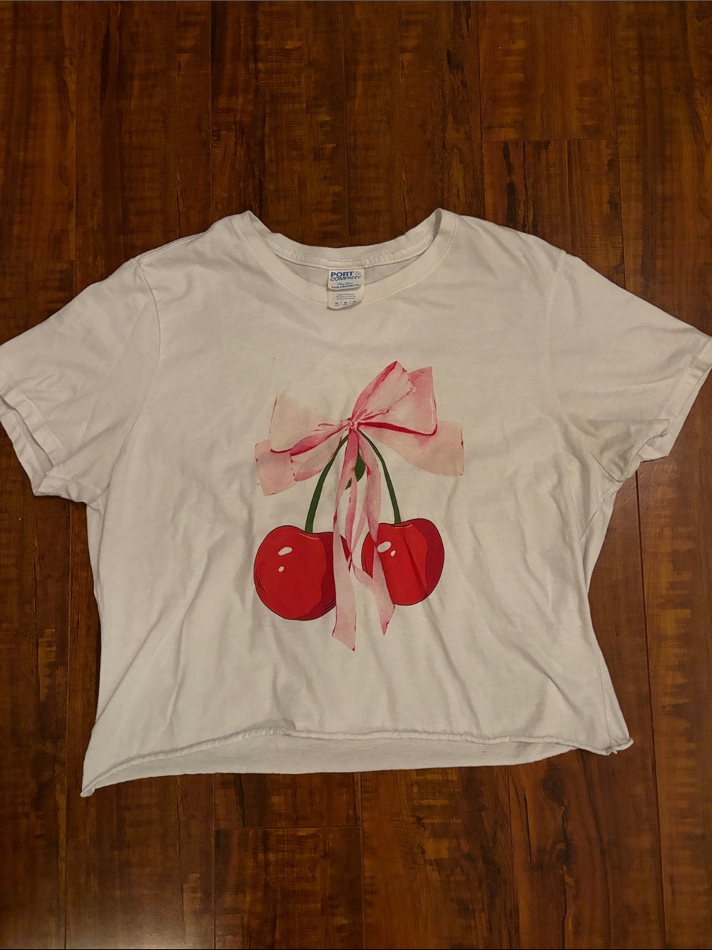 Port and Company White Crop Top with Red Cherry Graphic and Pink Bow